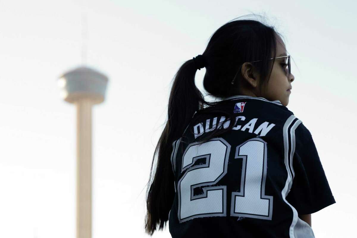 Serenity Saucedo, 9, sits on her dad Jerry Saucedo’s shoulders as they wait in line to enter the Alamodome in San Antonio, Texas, Friday, Jan. 13, 2023, to watch the San Antonio Spurs take on the Golden State Warriors.
