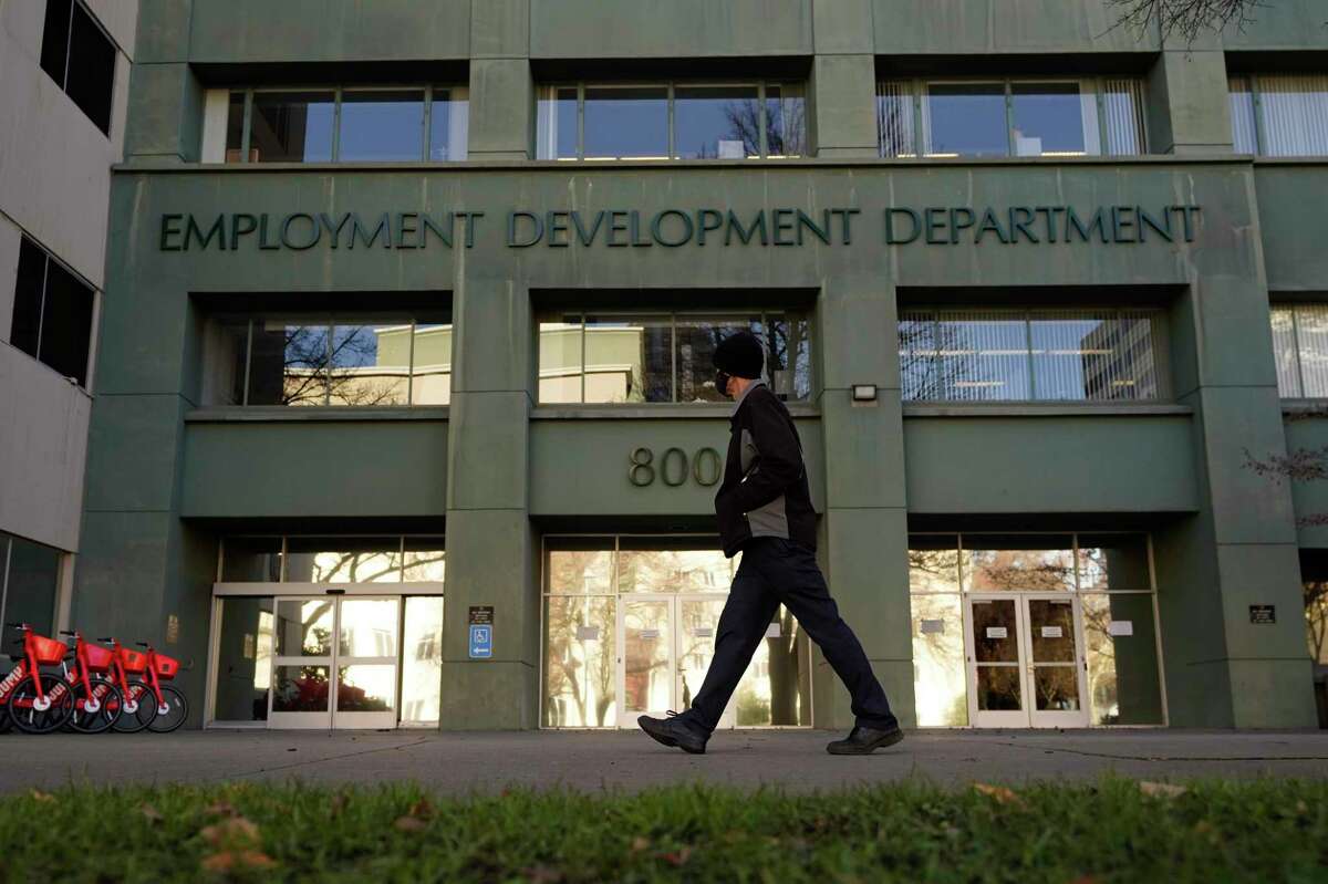 A person passes the office of the California Employment Development Department in Sacramento, Calif., in 2020.