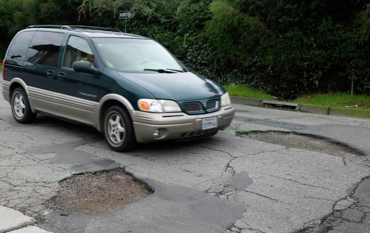 Potholes are vexing drivers throughout the Bay Area as the incessant rains erode roads. It’s a ever-recurring problem when storms get bad — here, a driver slows down to pass between two large potholes on Chatham Road in Oakland in winter 2017, another pothole-heavy year because of bad weather.