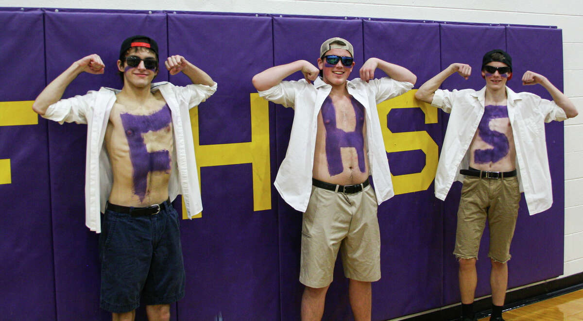 Members of the Frankfort student section flex and show off their body paint after a game against Benzie Central on Jan. 13 at Frankfort High School. 