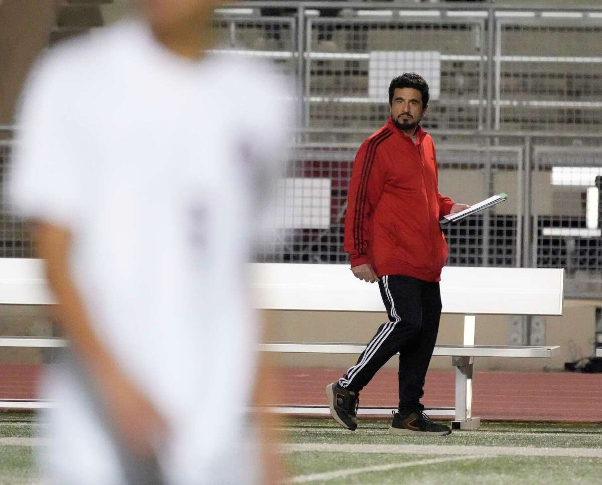 Alief Taylor head soccer coach Jose Leal coaches against his son, Emiliano Leal’s Tompkins high school team during the first half of a nondistrict boys soccer game at Crump Stadium on Friday, Jan. 13, 2023 in Houston.