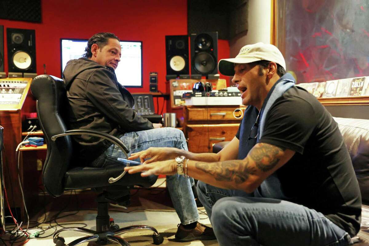 Former Texas State Rep. Poncho Nevárez, right, discusses one of his songs with AudioRec Productions recording studio owner and fellow musician, Reginaldo Sanchez Gonzalez, in Piedras Negras, Mexico, Tuesday, Dec. 20, 2022. Nevárez hit a staggering new low when in 2019 he accidentally dropped an envelope full of cocaine baggies while at the Austin airport, the undeniable physical proof of an addiction problem that had been festering for months. Three years later, he's managed to take back control of his life. He's clean, he's back to practicing law, and he's even embarked on a music career that's been a healthy outlet for expressing his feelings about his journey to recovery.