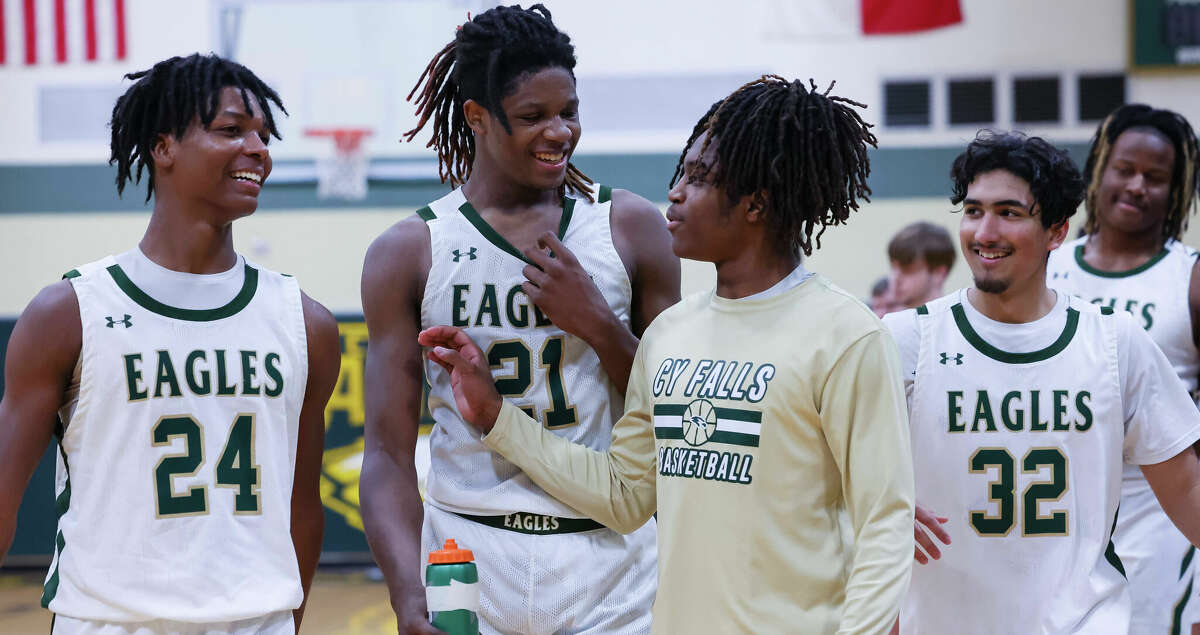 Cy Falls Eagles Daylon Porter (24), Joseph Tugler (21) and Asim Dadabhoy (32) celebrate their win against Cy Ranch after their District 16-6A boys high school basketball game at Cypress Falls High School in Houston, TX on Friday, January 13, 2023. Cy Falls beat Cy Ranch, 50-30.