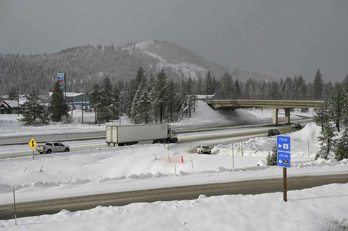 During a short break in the storm, a few travelers head west out of Truckee, Calif., toward Donner Summit on Jan. 8, 2023.