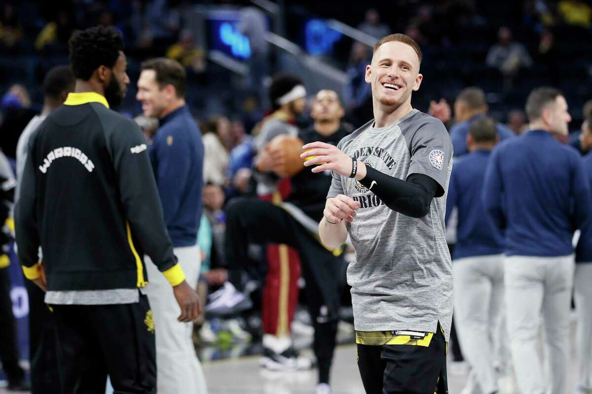 Golden State Warriors guard Donte DiVincenzo (0) warms up ahead of an NBA game against the Cleveland Cavaliers at Chase Center in San Francisco, Calif., Friday, Nov. 11, 2022.