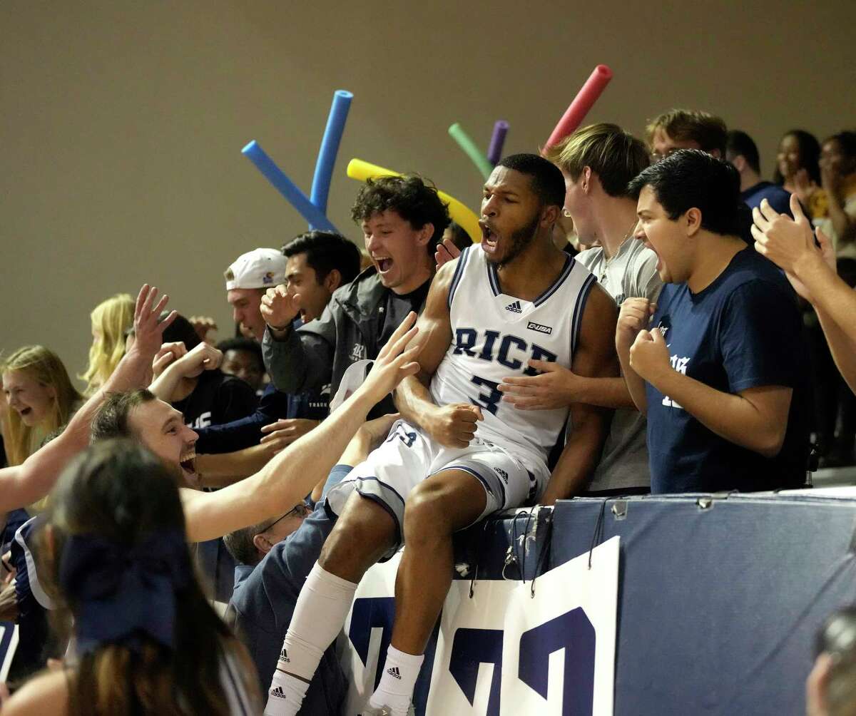Rice Owls Travis Evee jumps into the stands with fans as they celebrated his game winning shot at the buzzer to beat the UTEP Miners 83-82 during the second half of a NCAA mens basketball game at Tudor Field House on Saturday, Jan. 14, 2023 in Houston.