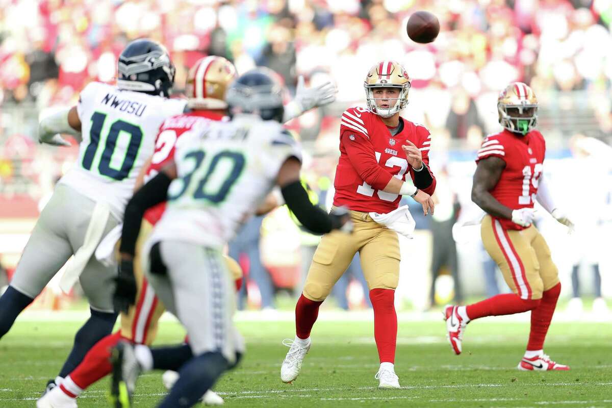 San Francisco 49ers’ Brock Purdy passes to Christian McCaffrey against Seattle Seahawks during 2nd quarter of NFC Wild Card Playoffs in Santa Clara, Calif., on Saturday, January 14, 2023.