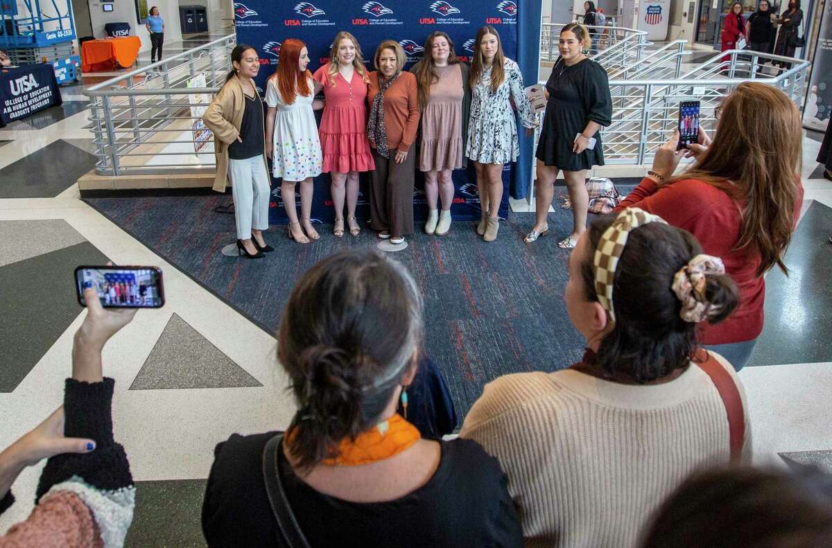 Students graduating from UTSA with teaching degrees pose Dec. 6, 2022 for pictures after an induction ceremony on the university campus.