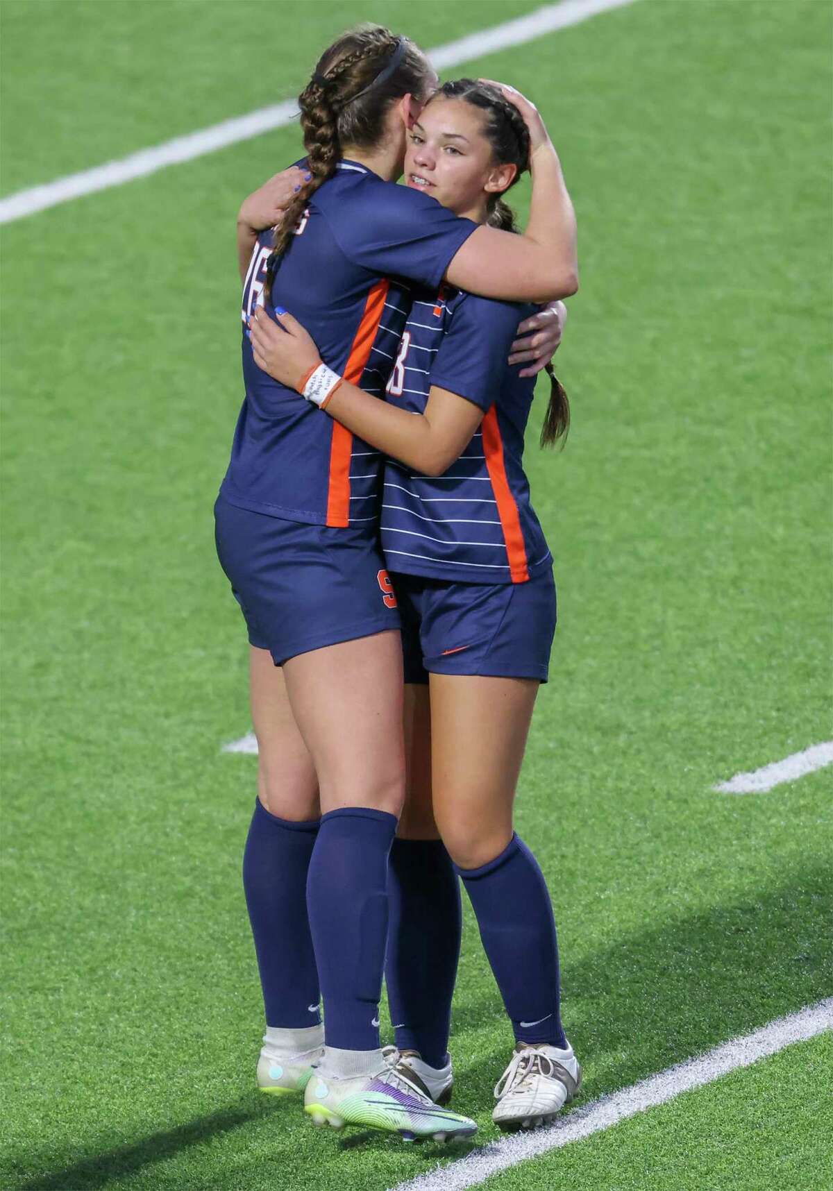Seven Lakes midfielder Wagoner Town (16) hugs Chloe Callahan (18) after defeating Cypress Woods in the I-10 Shootout, Spartan Bracket final on January 14, 2023 at Legacy Stadium in Katy, TX.