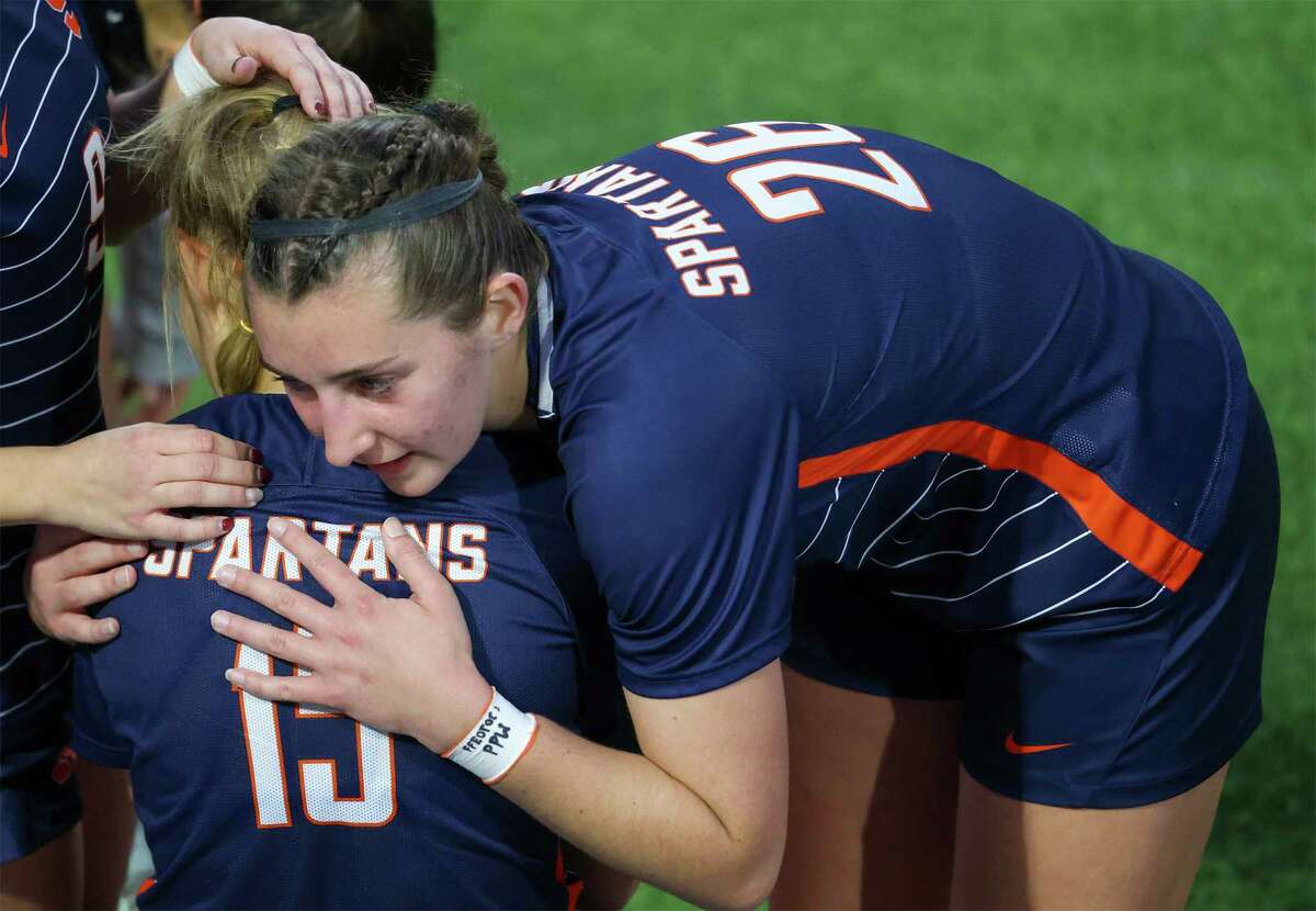Seven Lakes Katie Lennon (26) hugs Kennedy Reed (15) after defeating Cypress Woods in the I-10 Shootout, Spartan Bracket final on January 14, 2023 at Legacy Stadium in Katy, TX.