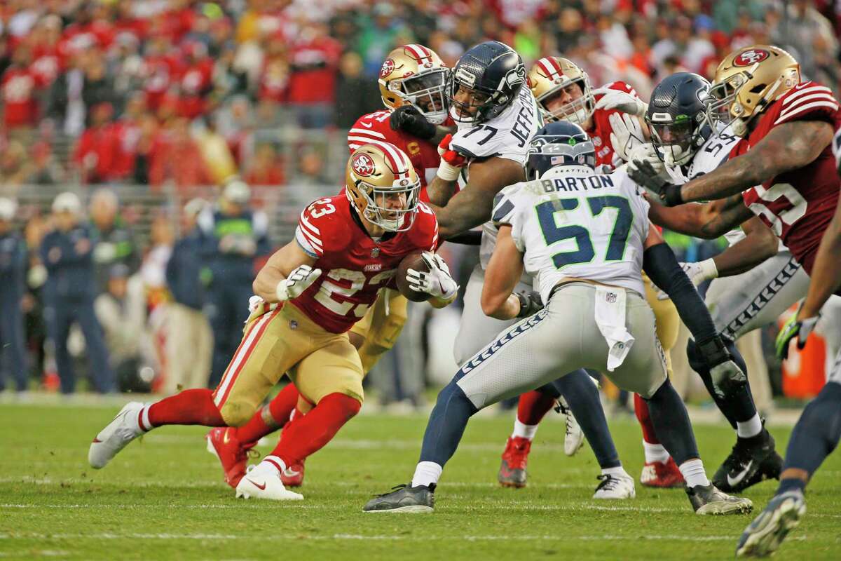 San Francisco 49ers running back Christian McCaffrey (23) runs for a gain against the Seattle Seahawks in the fourth quarter of an NFL wild-card round playoff game at Levi’s Stadium in Santa Clara, Calif., Saturday, Jan. 14, 2023.