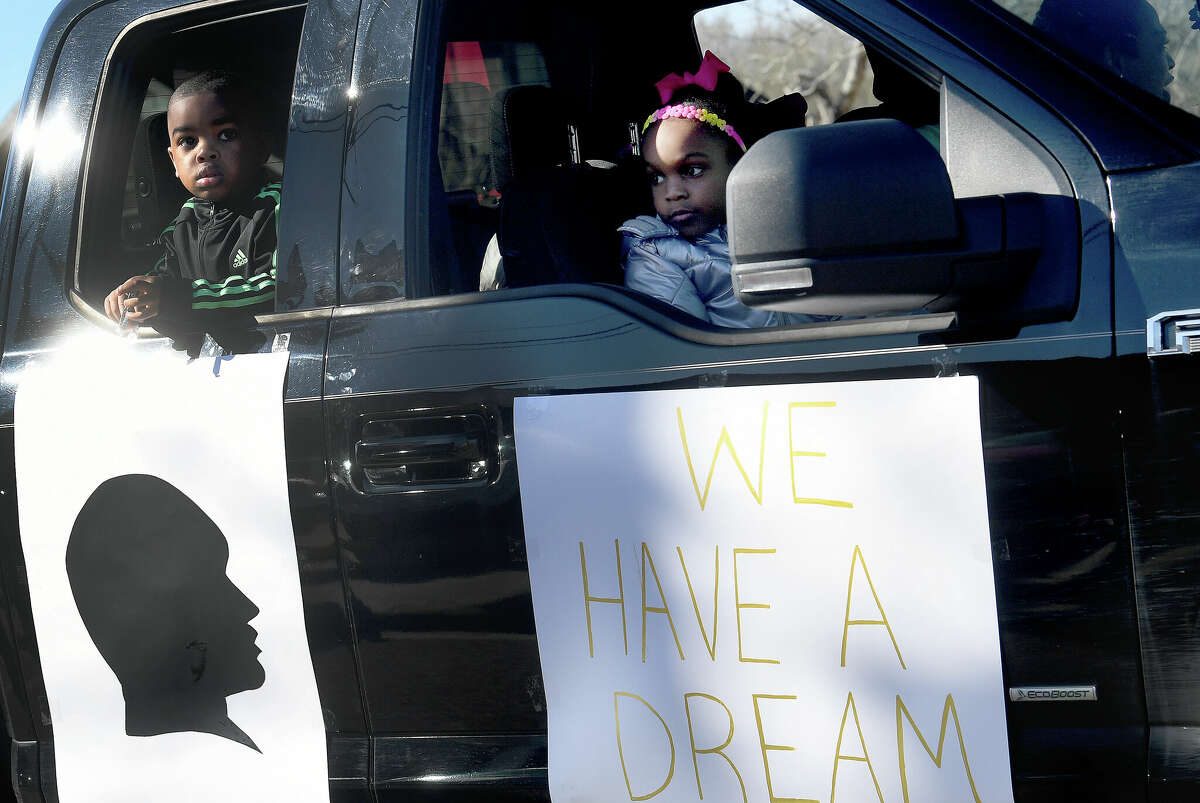 Children look out toward the crowd lining the route as the Martin Luther King, Jr., parade makes its way up Highland Avenue Saturday. Photo made Saturday, January 14, 2023 Kim Brent/Beaumont Enterprise