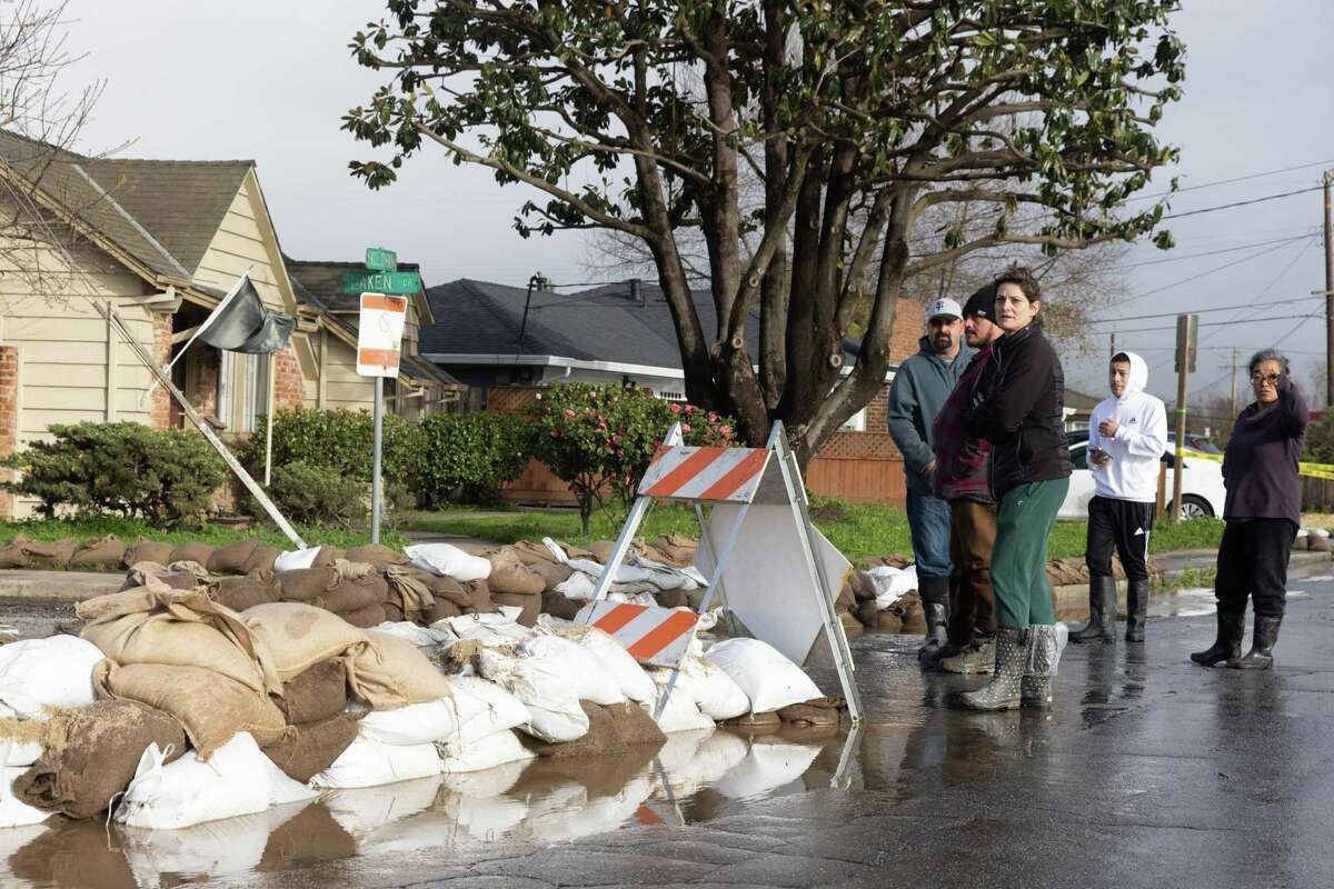 Neighbors use sandbags to stop flood water from reaching homes in Watsonville in mid-January.