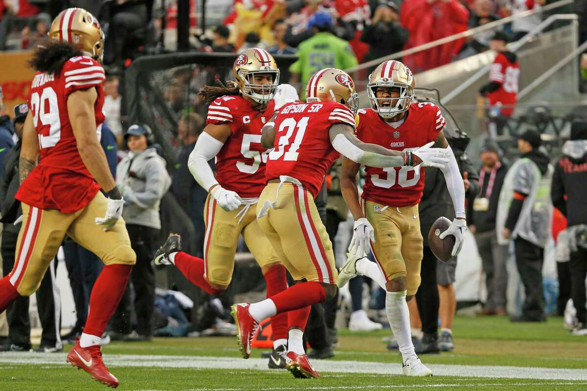 San Francisco 49ers cornerback Deommodore Lenoir (38) celebrates his interception against the Seattle Seahawks in the fourth quarter of an NFL wild-card round playoff game at Levi’s Stadium in Santa Clara, Calif., Saturday, Jan. 14, 2023.