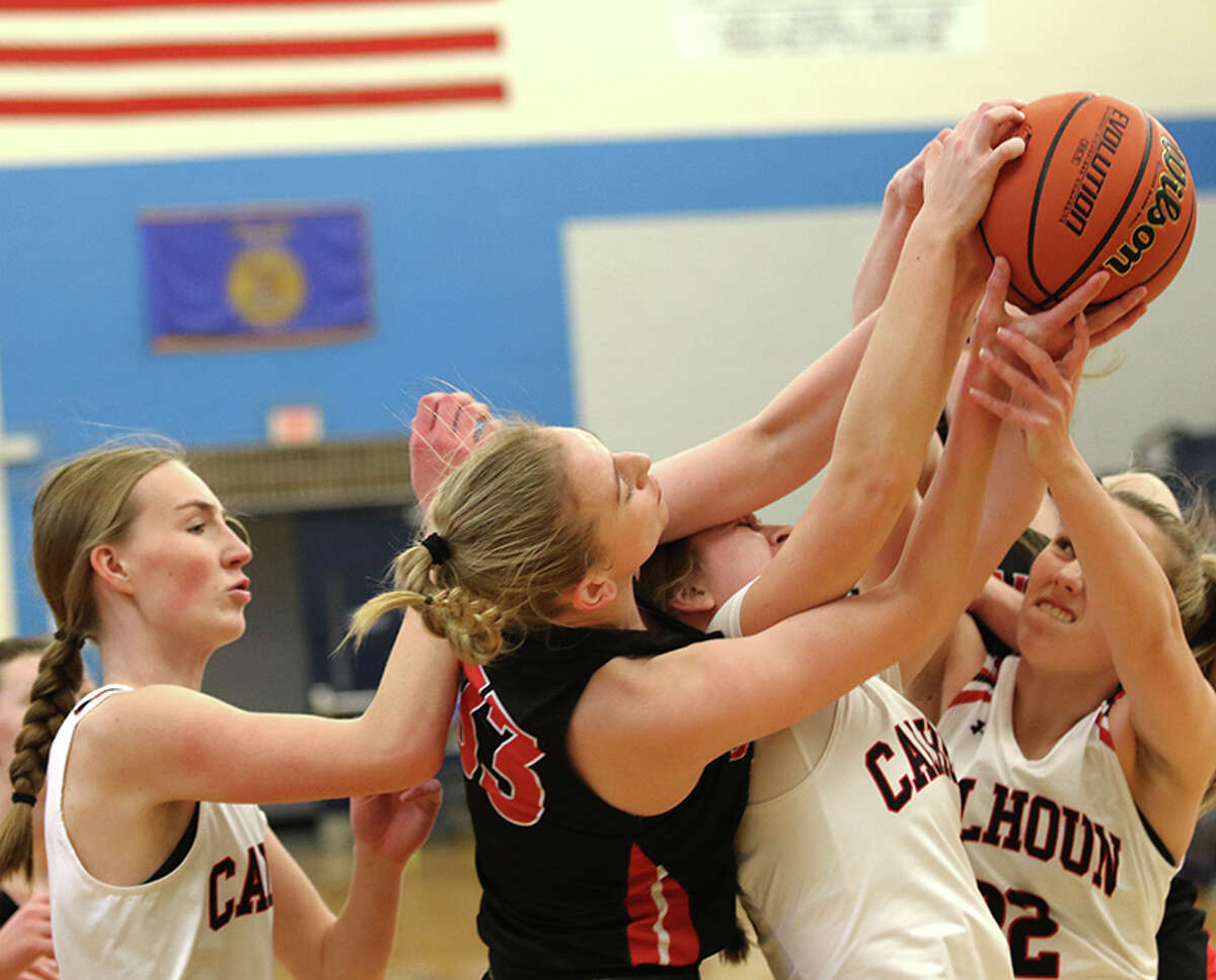 Calhoun's Haley Schnelten (right) and Lila Simon go for a rebound with the Warriors' Kate Zipprich (left) looking to connect to North Greene's lead play in the Lady Spartan Classic Saturday afternoon at White Hall, Pittsfield's Ellie Ten Eyck ( 33) fought with.