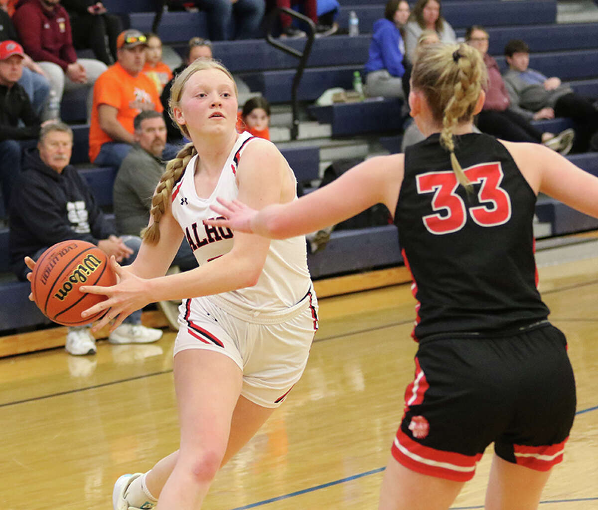 Calhoun's Audrey Gilman drives the ball to the basket against Pittsfield's Ellie Ten Eyck (33) in the title game of North Greene's Lady Spartan Classic Saturday afternoon at White Hall.