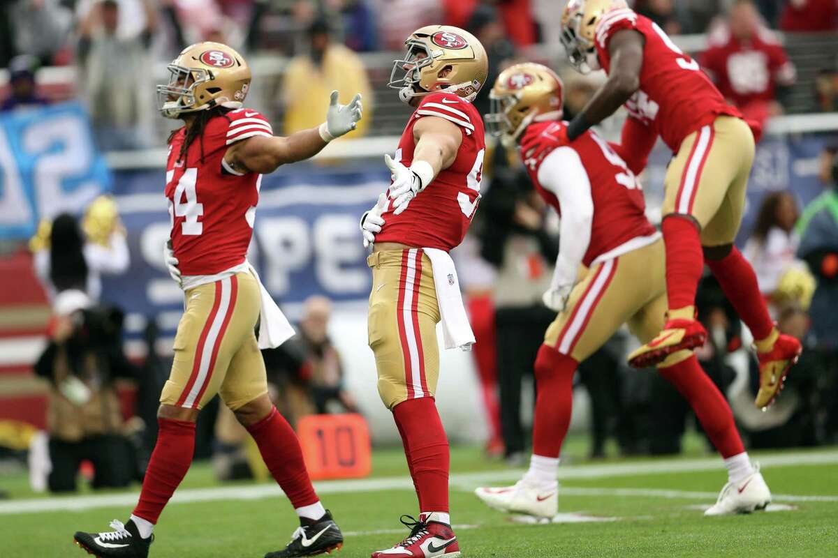 San Francisco’s Nick Bosa (center) and Fred Warner (left) celebrate a sack by Arik Armstead in the first quarter.