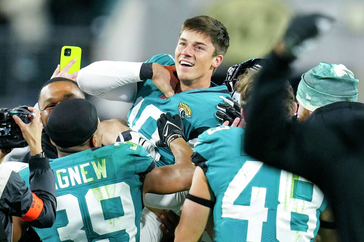 Jacksonville Jaguars place kicker Riley Patterson (10) and his team celebrate his game-winning field goal against the Los Angeles Chargers during the second half of an NFL wild-card football game, Saturday, Jan. 14, 2023, in Jacksonville, Fla. Jacksonville Jaguars won 31-30.