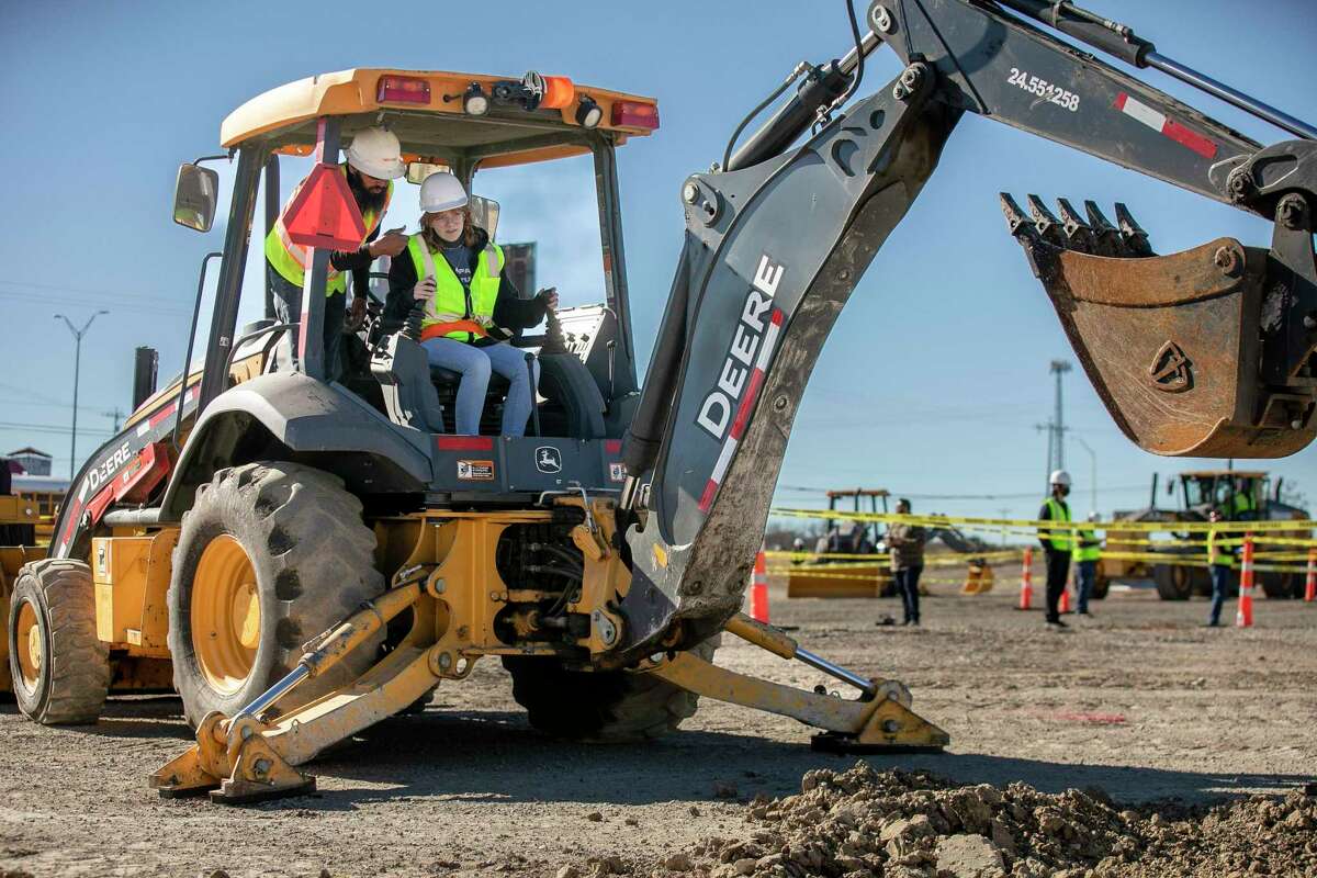 Tessa Lindsey, 16, of San Antonio, learns how to operate a back hoe during the ACE Mentor Program Construction Day event at RDO Equipment in New Braunfels on Friday. This was the first time in three years the event was held to offer mentoring in the fields of architecture, engineering and construction. The mentors provided job-site training to the students from the San Antonio area.