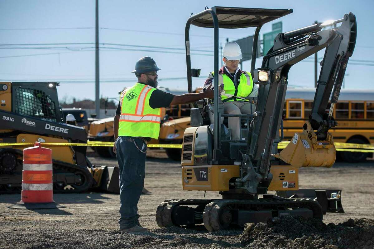 High school students get hands-on experience with heavy equipment