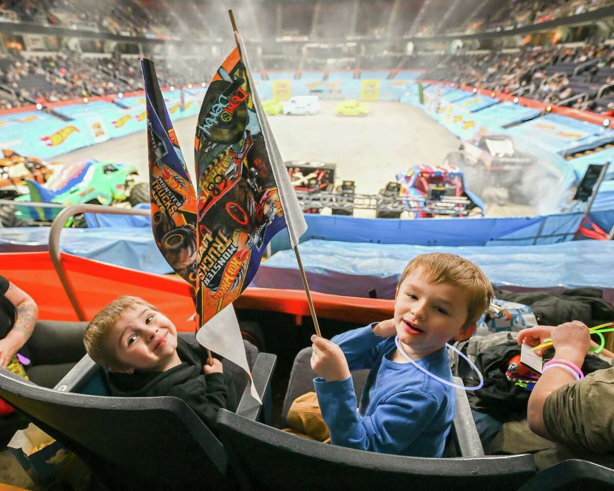 Ashton Ure, left, and Jeremiah Ellement waving the flag before the Hot Wheels Monster Trucks Live Glow Party kicks off at the MVP Arena in Albany, NY on Saturday, January 14, 2023.