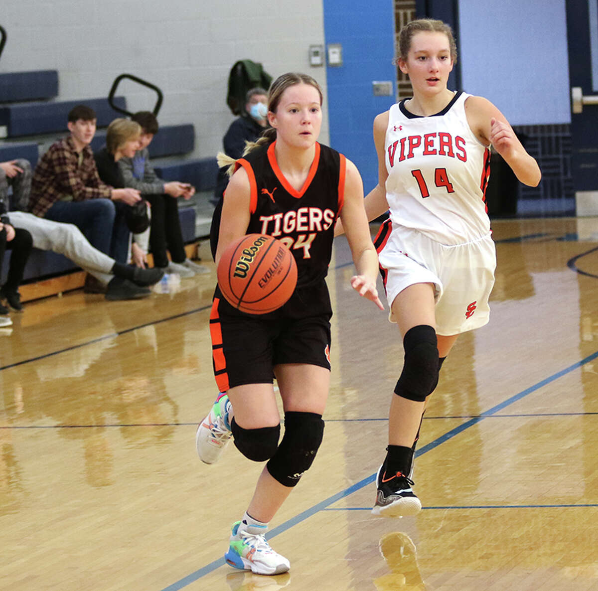 Greenfield's Addison Wright (left) drives past South County's Mae Bandelow in the third-place game of the Spartan Classic Saturday at White Hall.