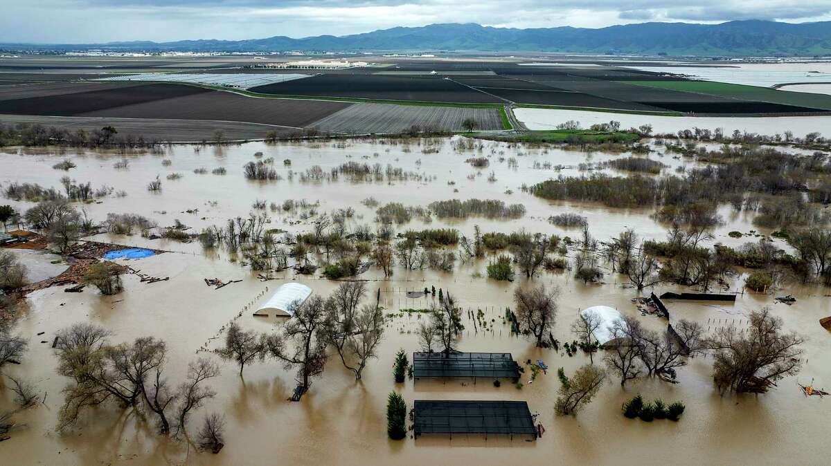 Floodwaters cover a property along River Rd. in Monterey County, Calif., as the Salinas River overflows its banks on Friday, Jan. 13, 2023.
