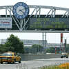FILE - A clock at the entrance to JFK Airport in New York is pictured on Aug. 15, 2003. Officials are investigating a close call at the New York airport that happened Friday, Jan. 13, 2023, between a plane that was crossing a runway and another that was preparing for takeoff.