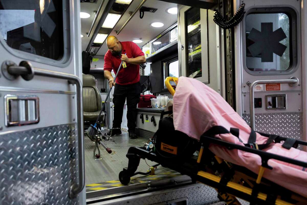EMT-in-training Joe Bordner cleans out an ambulance after transporting a patient.