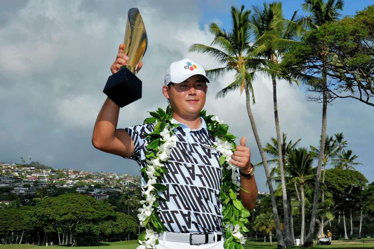 Si Woo Kim holds the champions trophy after the final round of the Sony Open golf tournament, Sunday, Jan. 15, 2023, at Waialae Country Club in Honolulu. (AP Photo/Matt York)