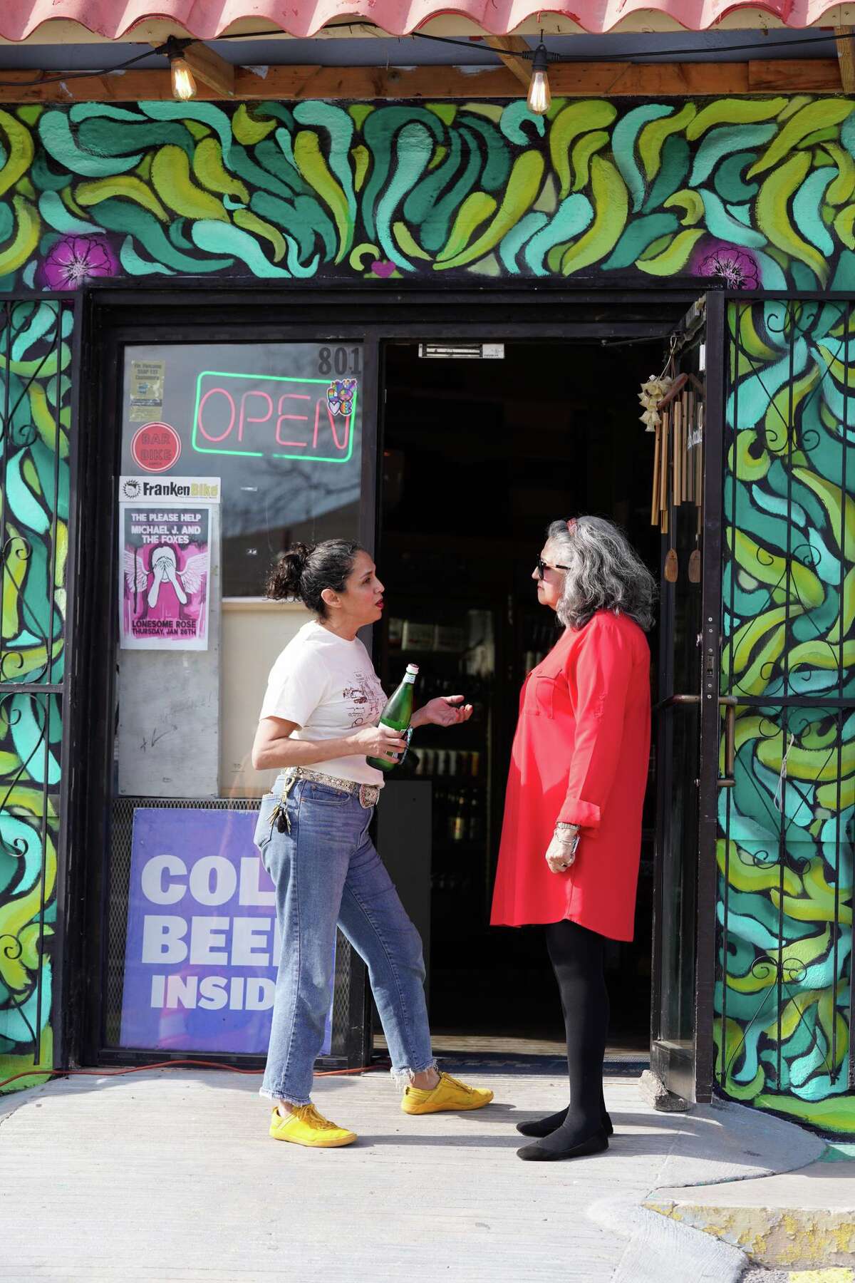 Owner Cynthia Gomez and Cindy Rodriquez-Martinez chat during a benefit Sunday to help raise funds for Oscar de la Tienda, an eclectic convenience store in the Alta Vista neighborhood that serves as a hub for other small businesses and local artists without brick and mortar shops of their own. Gomez said construction has severely impacted business and the store is “hanging on by a thread, operating at 25% of what average revenues should be.”