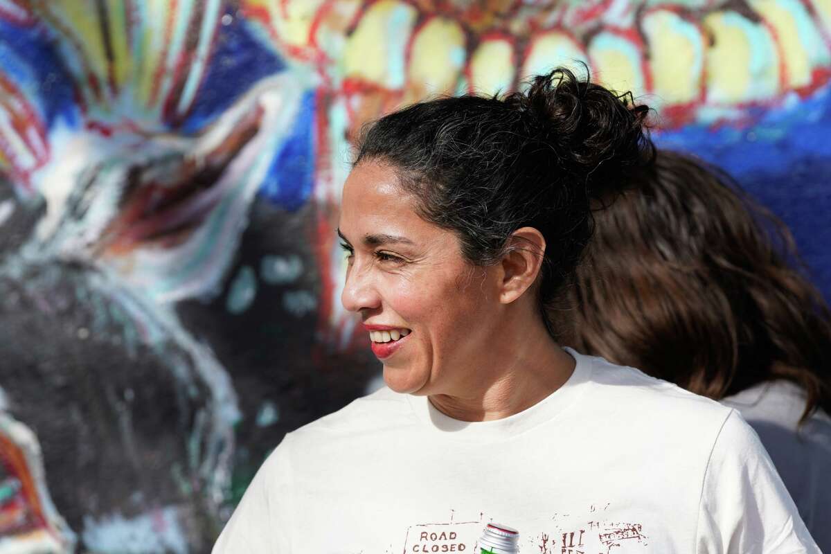 Owner Cynthia Gomez smiles during a benefit Sunday to help raise funds for Oscar de la Tienda, an eclectic convenience store in the Alta Vista neighborhood that serves as a hub for other small businesses and local artists without brick and mortar shops of their own. Gomez said construction has severely impacted business and the store is “hanging on by a thread, operating at 25% of what average revenues should be.”