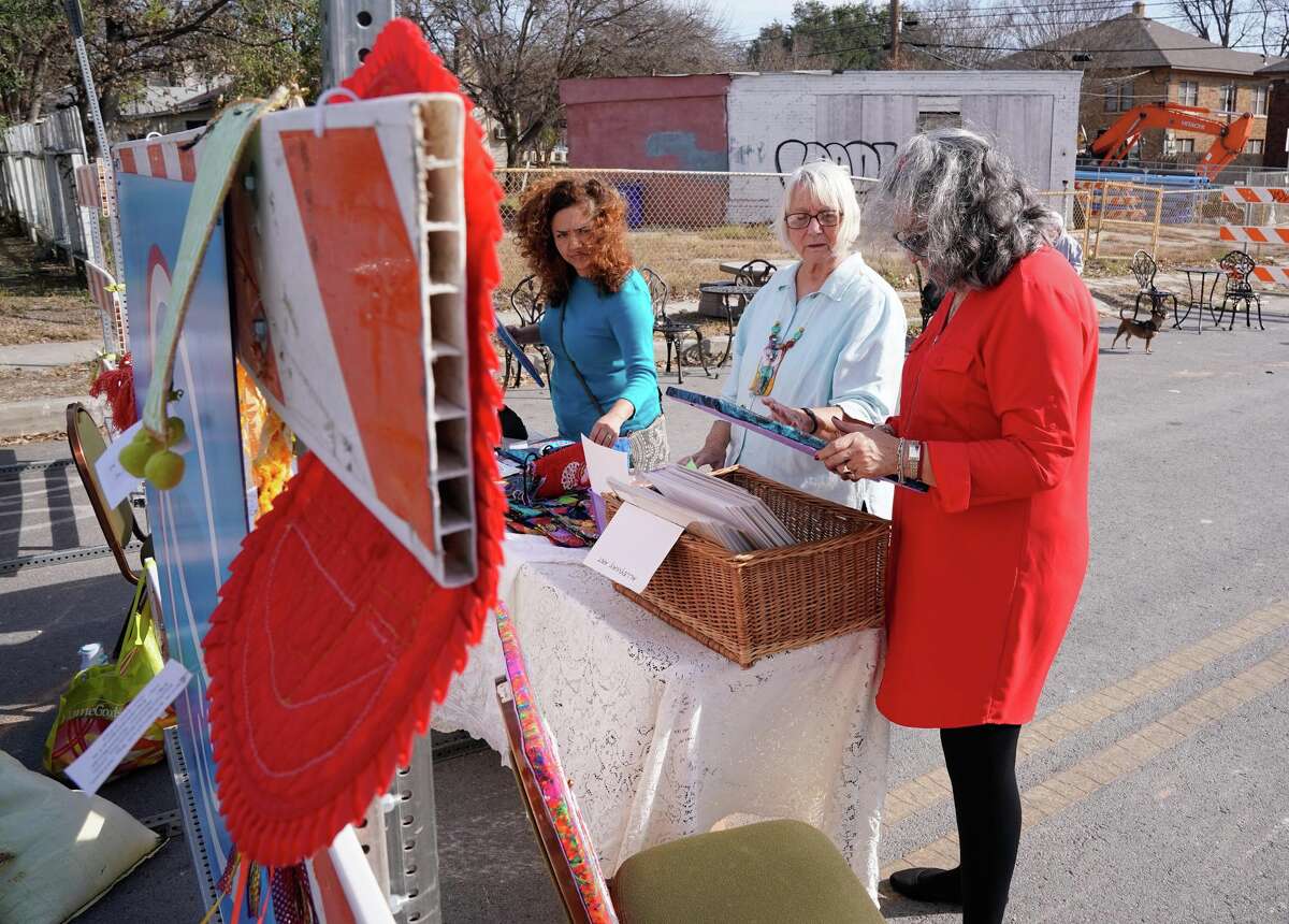Marisela Candelaria (left) and Cindy Rodriguez-Martinez (right) look over the items of artist Alison Schockner during a benefit Sunday to help raise funds for Oscar de la Tienda, an eclectic convenience store in the Alta Vista neighborhood that serves as a hub for other small businesses and local artists without brick and mortar shops of their own. Gomez said construction has severely impacted business and the store is “hanging on by a thread, operating at 25% of what average revenues should be.”