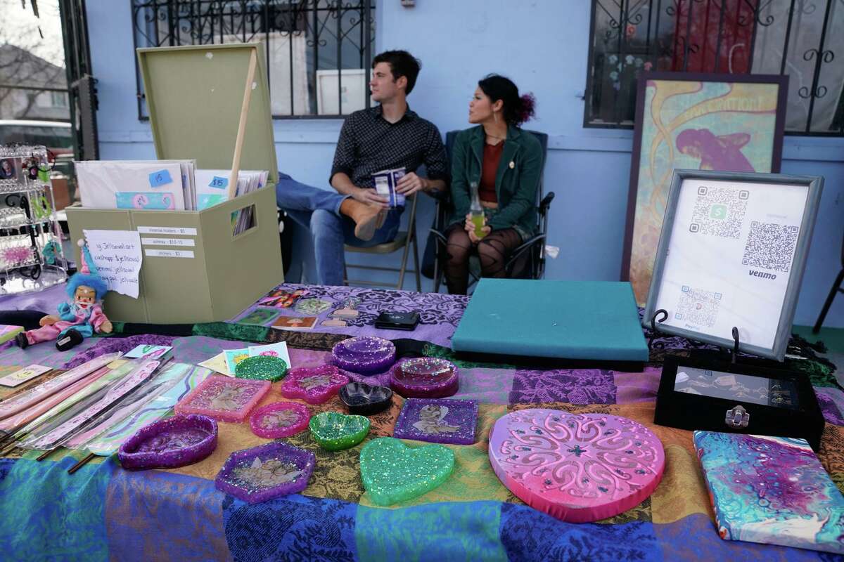Angelica Ovalle of Jellsoval Art and Sean Garcia watch over her booth during a benefit Sunday to help raise funds for Oscar de la Tienda, an eclectic convenience store in the Alta Vista neighborhood that serves as a hub for other small businesses and local artists without brick and mortar shops of their own. Gomez said construction has severely impacted business and the store is “hanging on by a thread, operating at 25% of what average revenues should be.”
