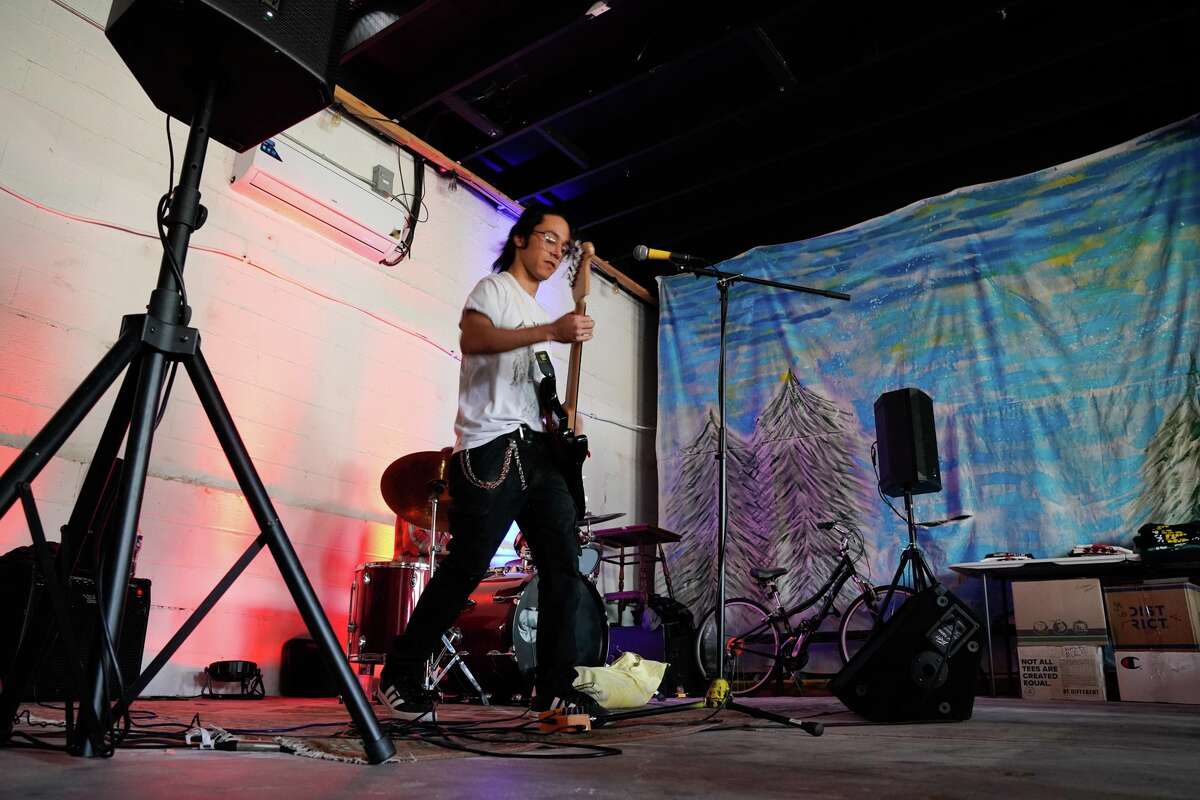 The band “Atomic Boredom” performs during a benefit Sunday to help raise funds for Oscar de la Tienda, an eclectic convenience store in the Alta Vista neighborhood that serves as a hub for other small businesses and local artists without brick and mortar shops of their own. Gomez said construction has severely impacted business and the store is “hanging on by a thread, operating at 25% of what average revenues should be.”