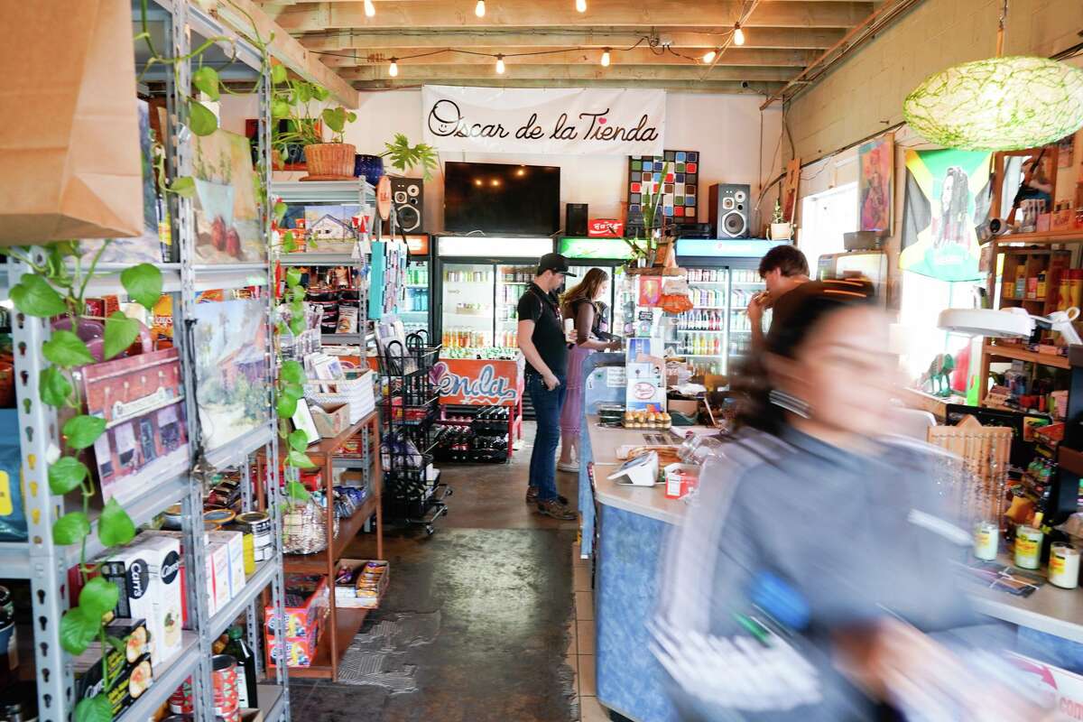 People shop during a benefit Sunday to help raise funds for Oscar de la Tienda, an eclectic convenience store in the Alta Vista neighborhood that serves as a hub for other small businesses and local artists without brick and mortar shops of their own. Gomez said construction has severely impacted business and the store is “hanging on by a thread, operating at 25% of what average revenues should be.”