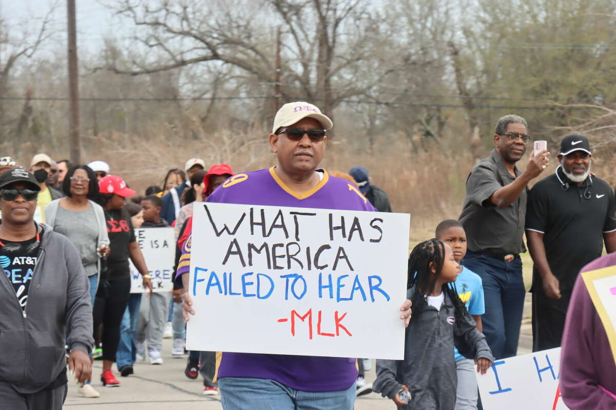 Horace Broussard, Jr. walks down the street during the annual MLK Day march on Monday, Jan. 16, 2023, in Orange.
