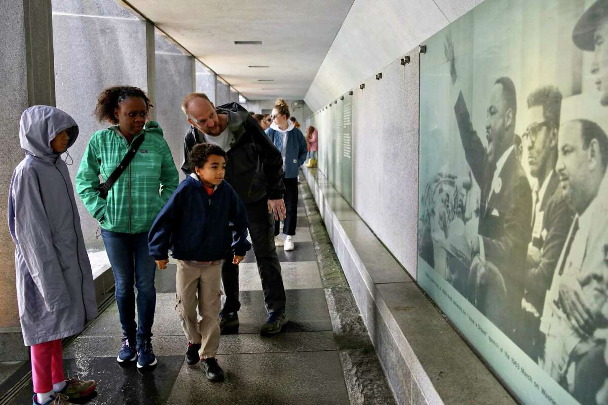 The Maxwell family from Mendocino — Sahara, 10 (left); mother Michelle; Maxwell, 8; and father Clinton — view the Martin Luther King Jr. Memorial behind the waterfall at Yerba Buena Gardens in San Francisco.