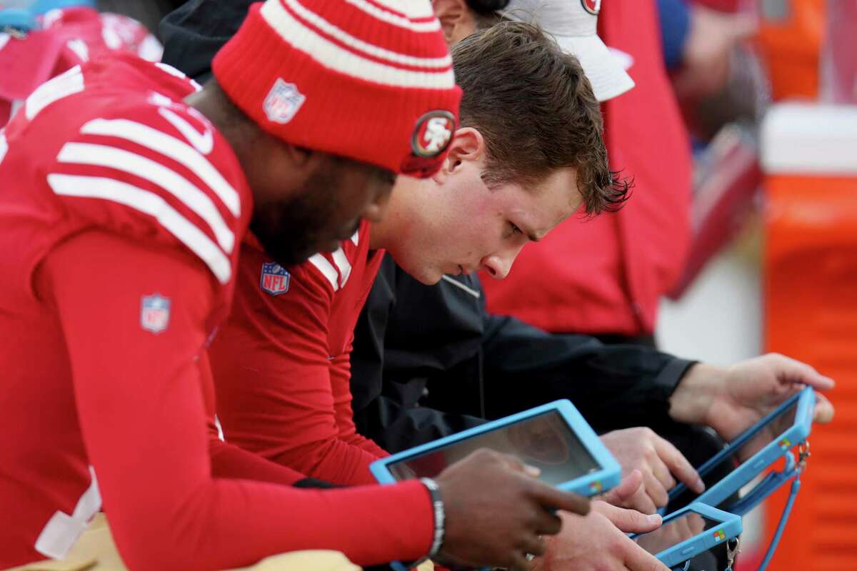 San Francisco 49ers quarterback Brock Purdy (13) reviews a tablet during an NFL wild card playoff football game against the Seattle Seahawks on Saturday, Jan.14, 2023, in Santa Clara, Calif. (AP Photo/Scot Tucker)