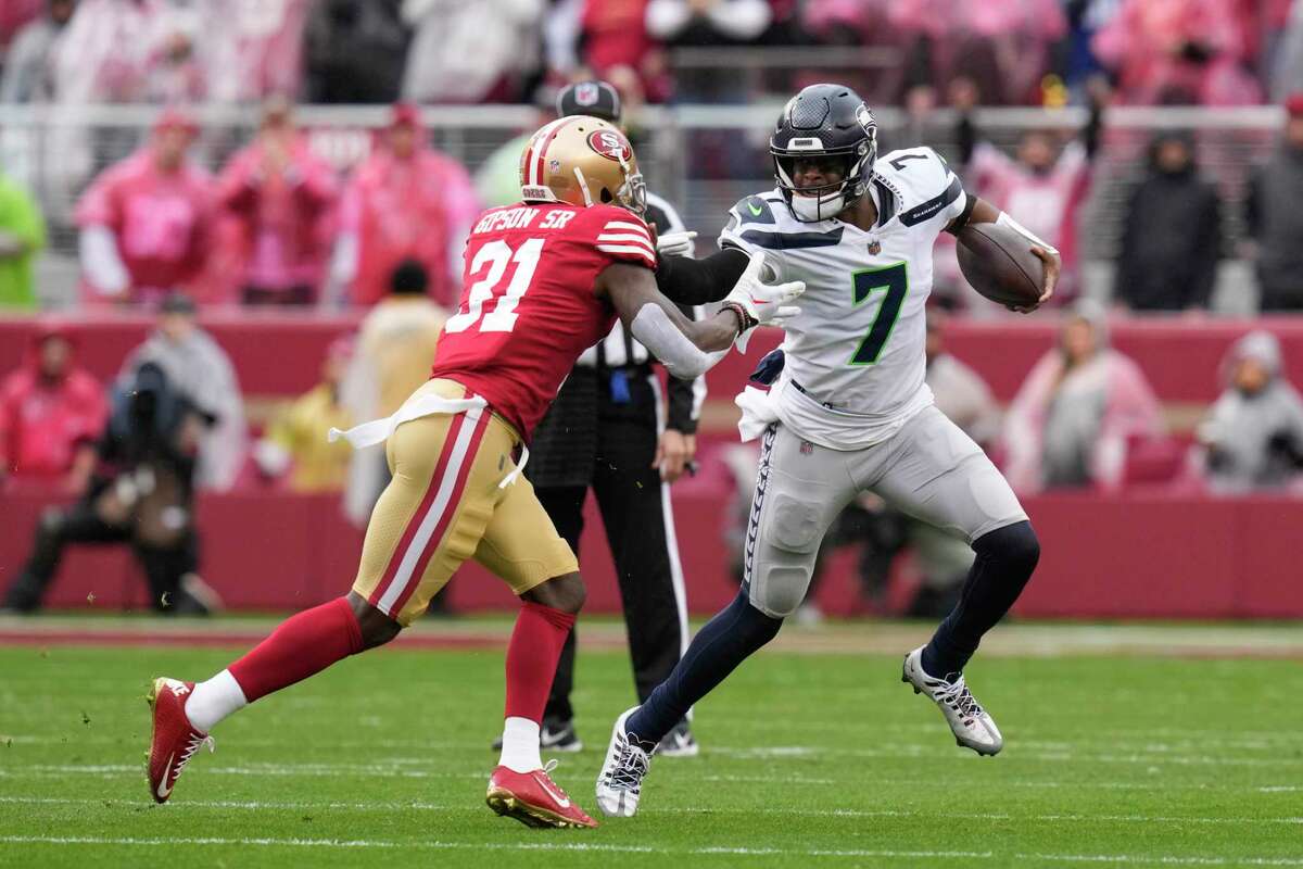 Seattle quarterback Geno Smith, pursued by 49ers safety Tashaun Gipson Sr., was 9 of 10 in the first half for 104 yards and a touchdown. But after halftime he lost a fumble and was picked off.