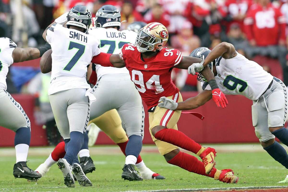 San Francisco 49ers’ Charles Omenihu pressures Seattle Seahawks’ Geno Smith during Niners’ 41-23 win in NFC Wild Card Playoffs in Santa Clara, Calif., on Saturday, January 14, 2023.