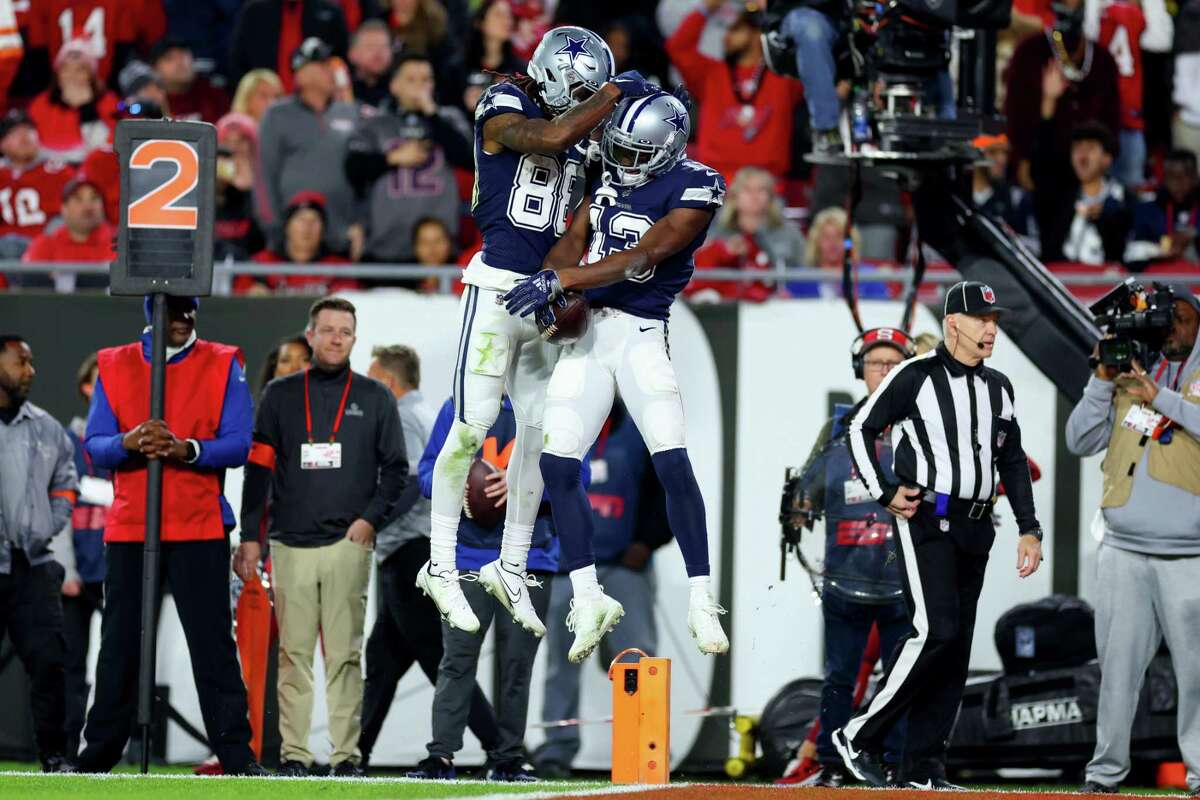 TAMPA, FLORIDA - JANUARY 16: Michael Gallup #13 of the Dallas Cowboys celebrates with CeeDee Lamb #88 after scoring a touchdown against the Tampa Bay Buccaneers during the third quarter in the NFC Wild Card playoff game at Raymond James Stadium on January 16, 2023 in Tampa, Florida. (Photo by Mike Ehrmann/Getty Images)
