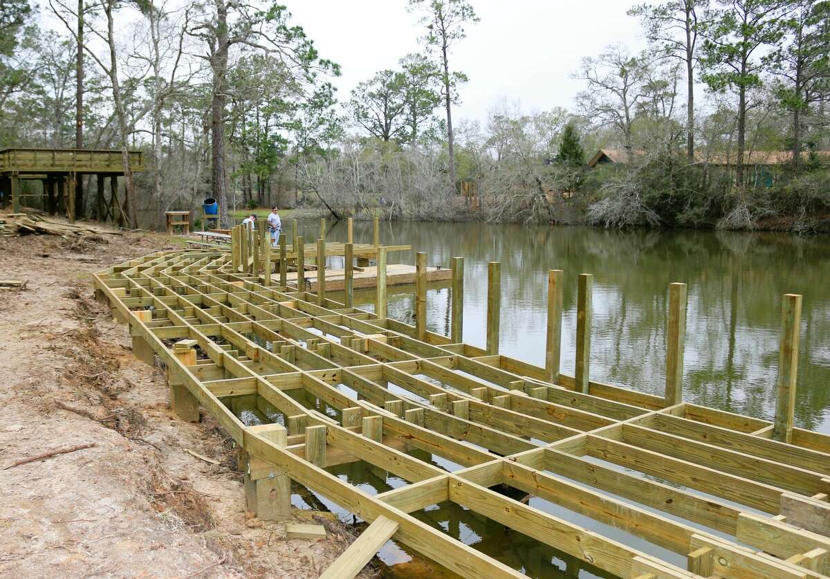 A pair of anglers check out the skeleton of a fishing pier being constructed at Alvin's Camp Mohawk. 
