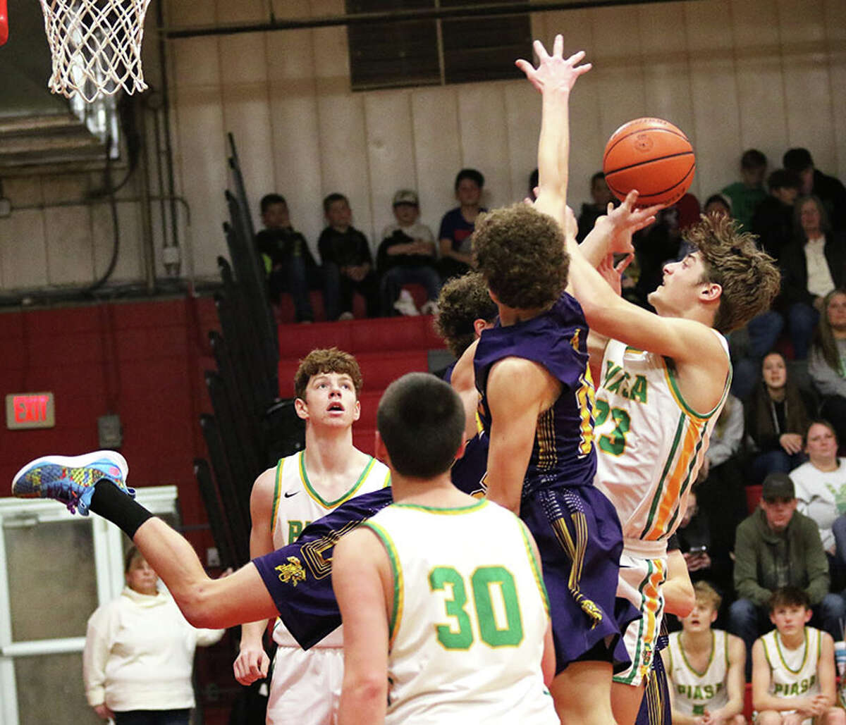 Southwestern's Greyson Brewer (right) puts up a shot against Mount Olive on Monday in a first-round game of the 104th annual Macoupin County Tournament at Hlafka Hall in Bunker Hill.