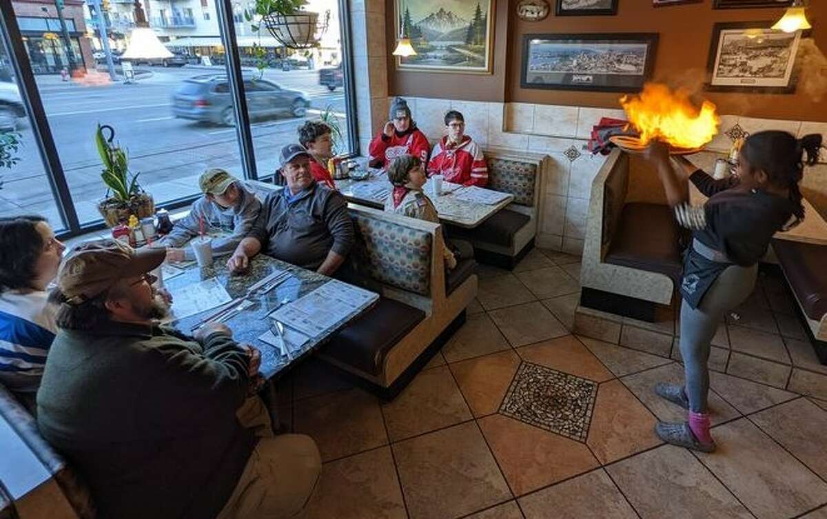 Members of Scout Troop 10 enjoy cheese flambe at Woodward Coney Island during their trip to the Detroit area from Jan. 13 through Jan. 15. 