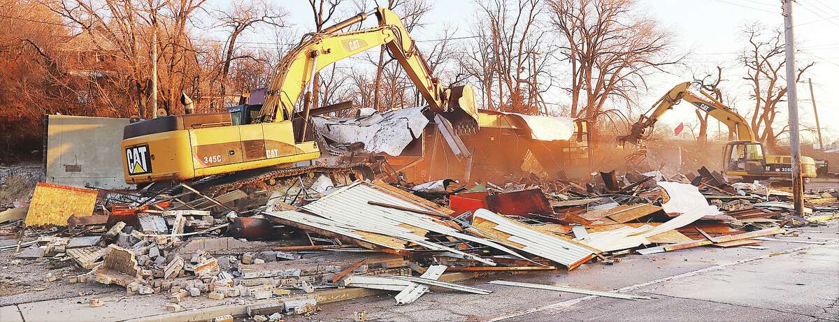 John Badman|The Telegraph Two trackhoes on Tuesday morning reduced the building at 1430 East Broadway to rubble in less than an hour.