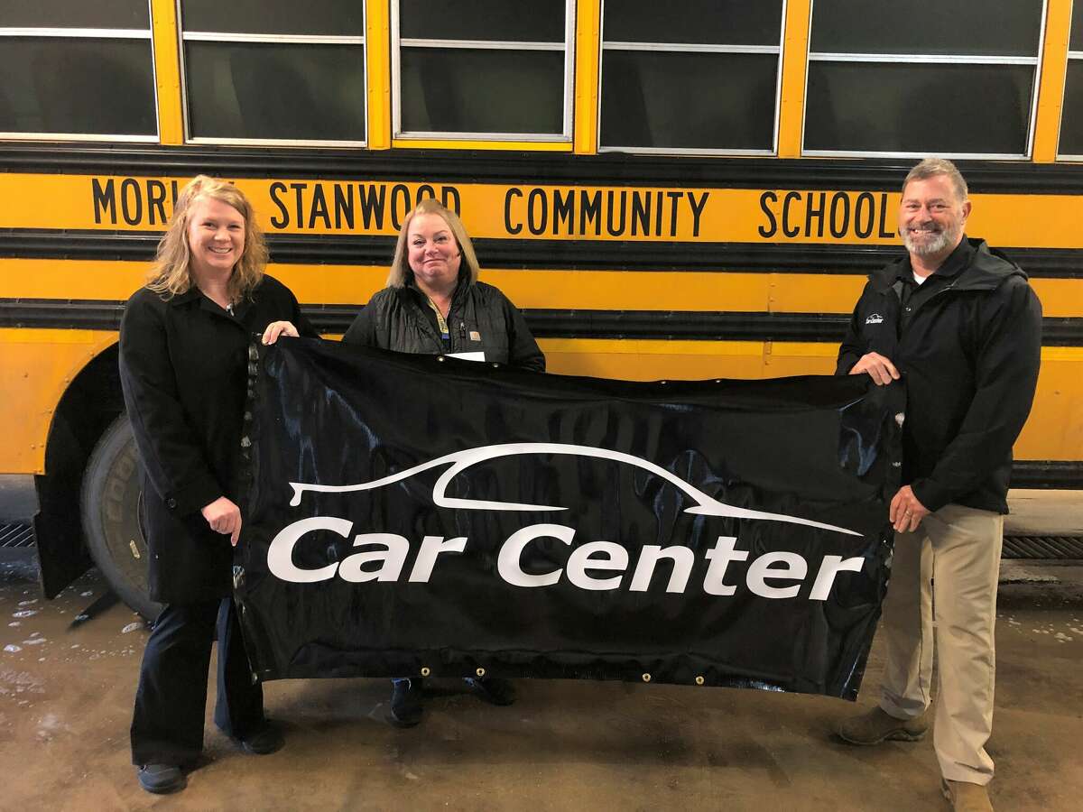 Kristy Thompson (center) poses for a photo with John Schreiber (right) and Amanda Nelson (left) following being named the Car Center of Big Rapids Morley Stanwood Community Schools Employee of the Month for December.