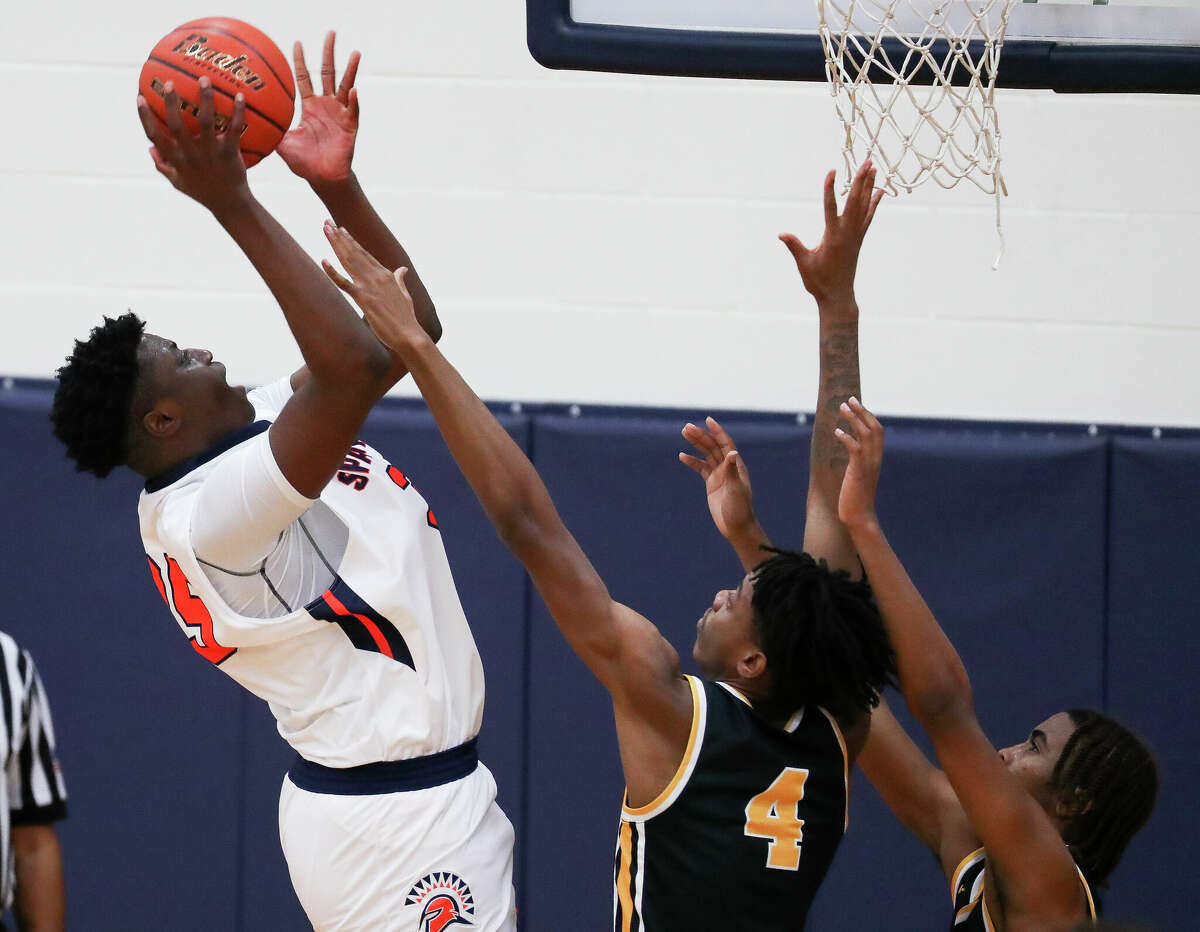 Seven Lakes center Josh Akpovwa (35) shoots over Fort Bend Marshall forward Naheim Northern (4) in the fourth quarter of a non-district high school basketball game at Seven Lakes High School, Thursday, Dec. 1, 2022, in Katy.