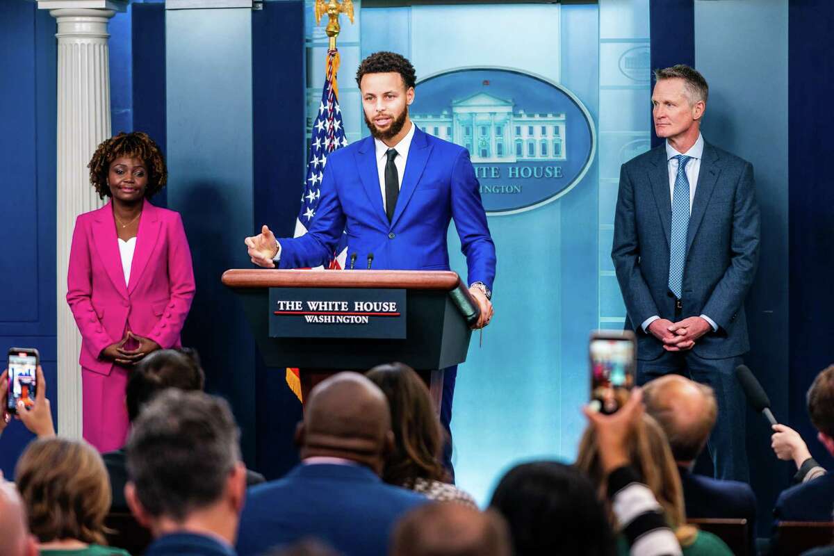 Stephen Curry speaks during the daily press briefing with White House press secretary Karine Jean-Pierre and Coach Steve Kerr nearby.