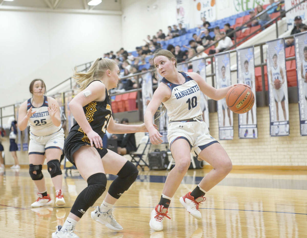 Greenwood's Avree Turnage dribbles while being guarded by Seminole's Olivia Hicks during a District 3-4A girls basketball game, Jan. 17 at the Greenwood gym. Greenwood's Grace Gardenhire calls for the ball on the right. 
